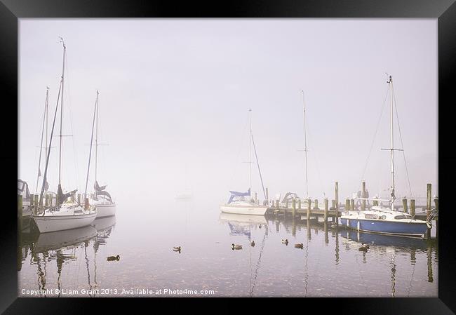 Boats in fog on Lake Windermere. Framed Print by Liam Grant