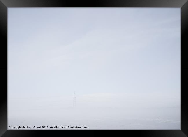 Electricity pylon in freezing fog. Framed Print by Liam Grant