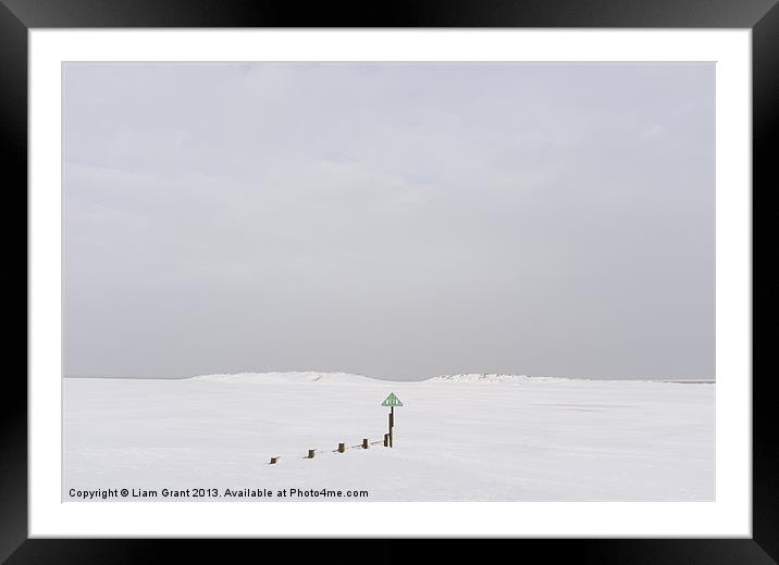 Beach and sand dunes covered in snow. Framed Mounted Print by Liam Grant
