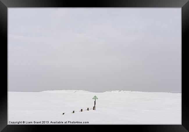 Beach and sand dunes covered in snow. Framed Print by Liam Grant