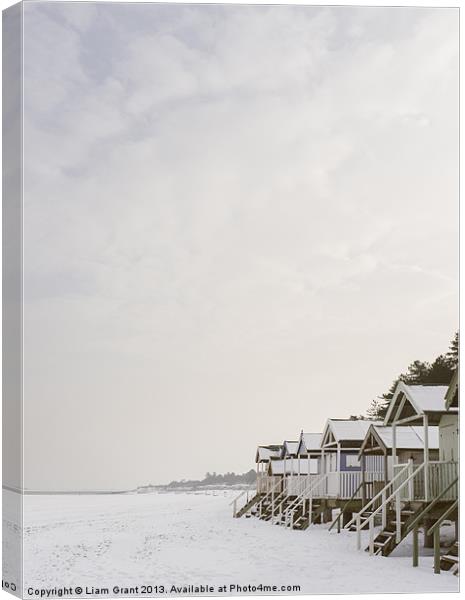 Beach huts covered in snow. Canvas Print by Liam Grant