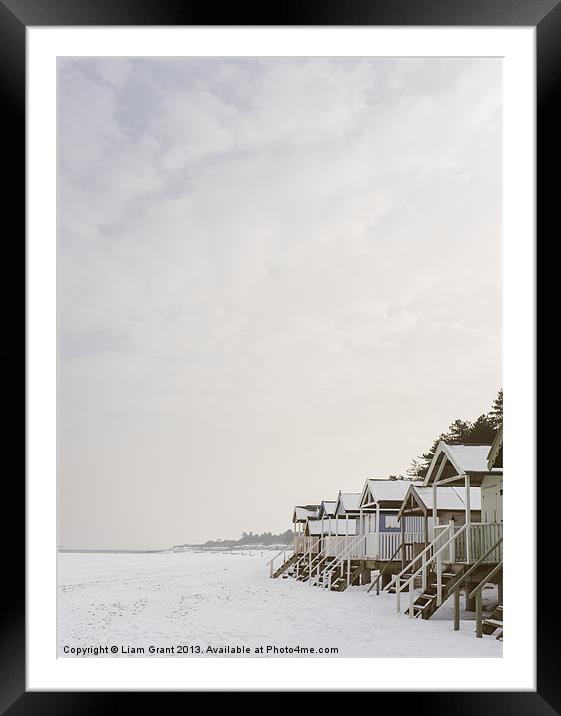 Beach huts covered in snow. Framed Mounted Print by Liam Grant