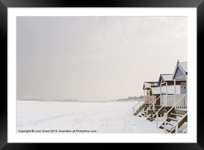 Beach huts covered in snow. Framed Mounted Print by Liam Grant