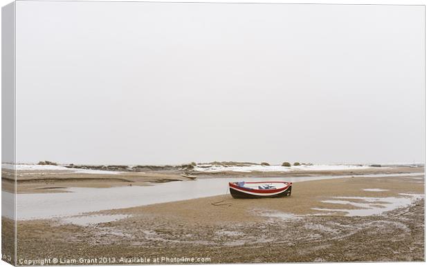 Boat and snow. Burnham Overy Staithe. Canvas Print by Liam Grant