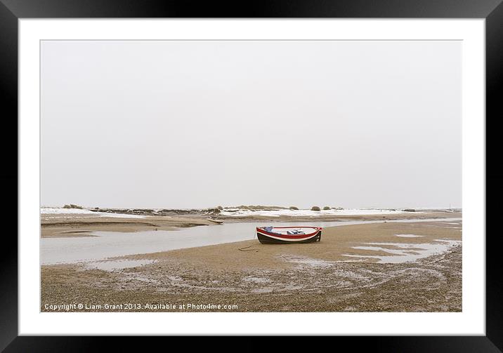 Boat and snow. Burnham Overy Staithe. Framed Mounted Print by Liam Grant