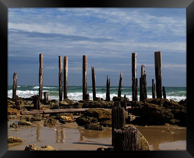 crumbling pier at low tide Framed Print by David Worthington