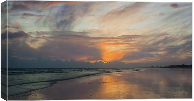 Sunset on a deserted beach Canvas Print by Ian Jones