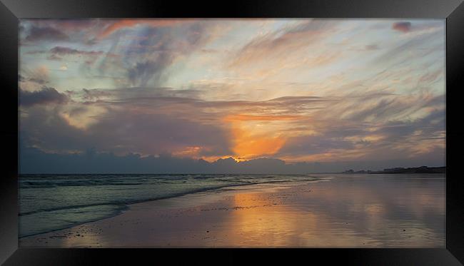 Sunset on a deserted beach Framed Print by Ian Jones