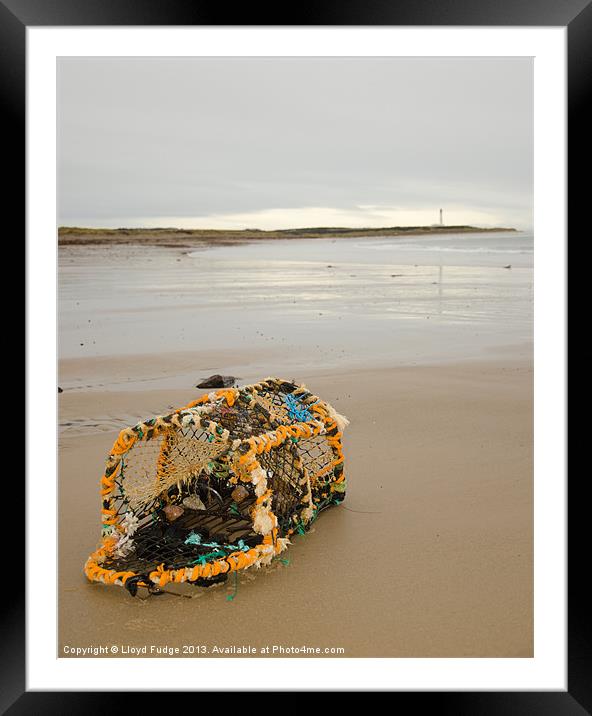 lobster pot laying on beach Framed Mounted Print by Lloyd Fudge
