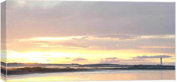 sunset over Lossiemouth beach and lighthouse Canvas Print by Lloyd Fudge