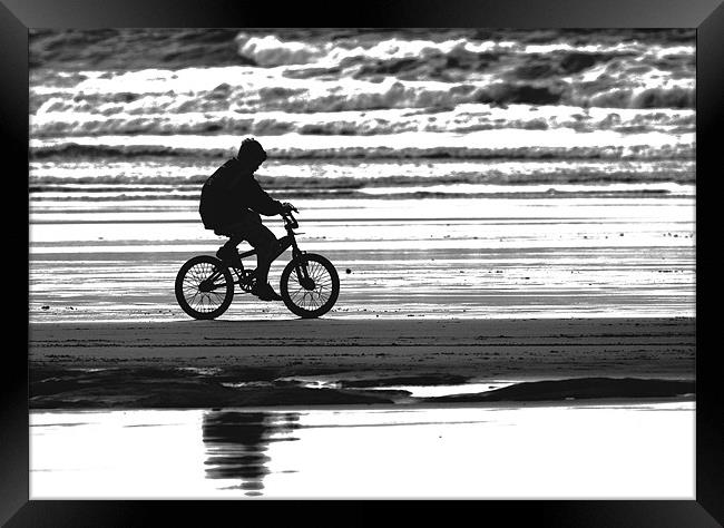 Lone Biker on Westward Ho! beach Framed Print by Mike Gorton