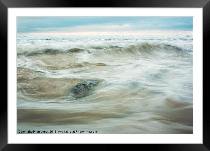 Flowing water on a beach Framed Mounted Print by Ian Jones