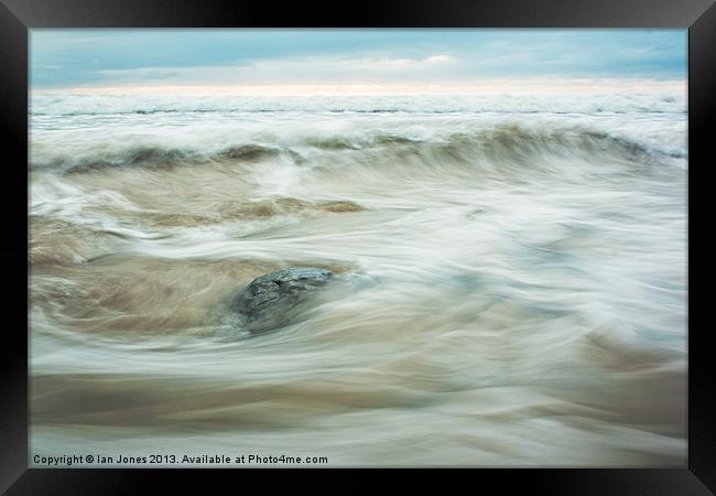 Flowing water on a beach Framed Print by Ian Jones
