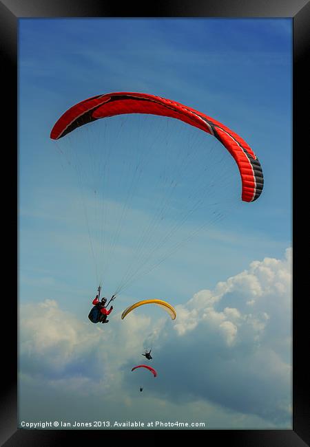 Paragliding on the coast Framed Print by Ian Jones