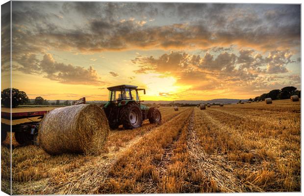 Tractor Harvesting Sunset Canvas Print by Simon West