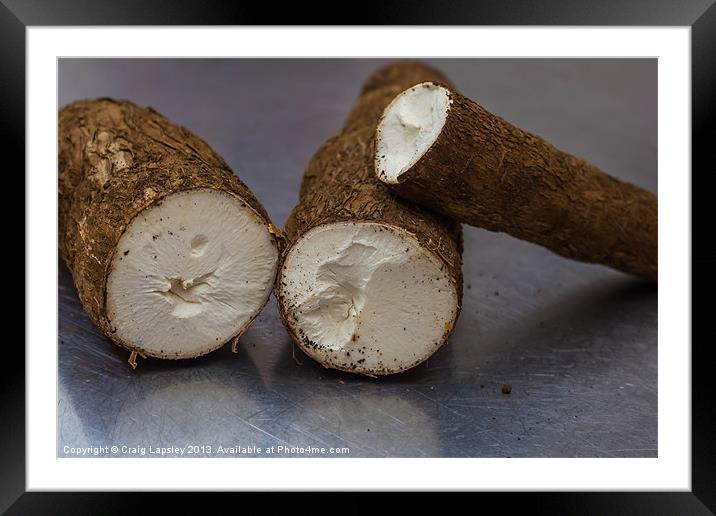yuca roots on the kitchen table Framed Mounted Print by Craig Lapsley