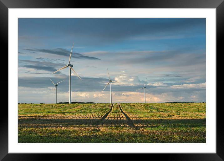 Wind turbines on a Windfarm at sunset. Framed Mounted Print by Liam Grant