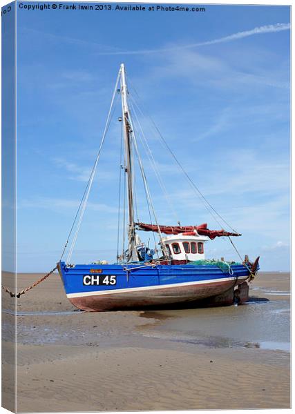 A beached yacht waiting for the incoming tide. Canvas Print by Frank Irwin