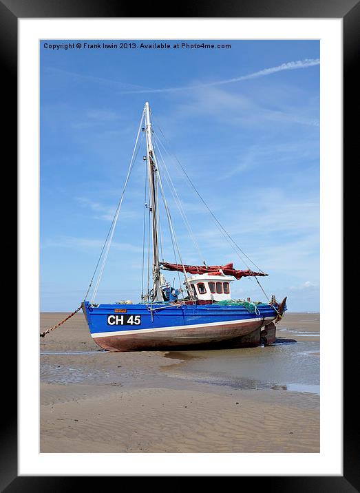 A beached yacht waiting for the incoming tide. Framed Mounted Print by Frank Irwin