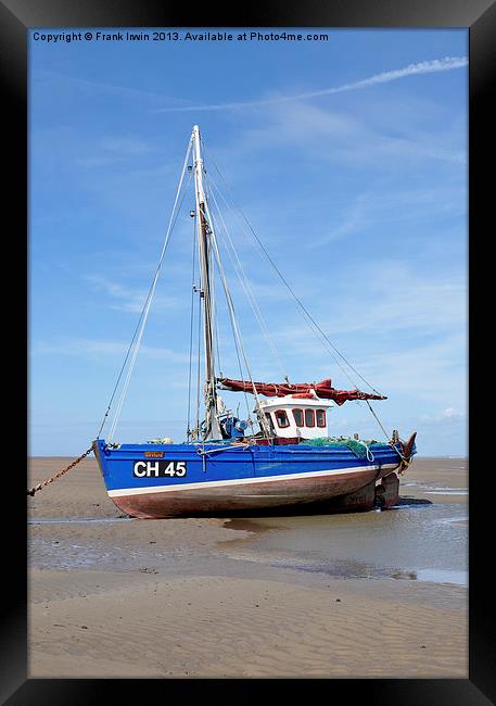 A beached yacht waiting for the incoming tide. Framed Print by Frank Irwin