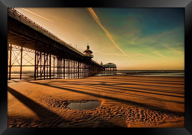 Shadows Of The Pier Framed Print by John Hare