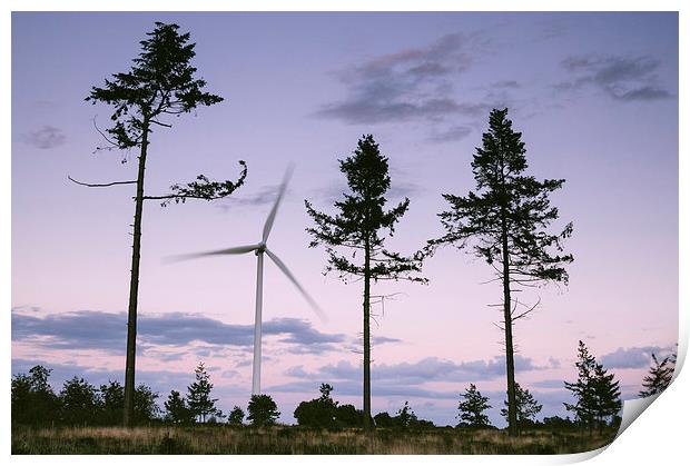 Wind turbine framed between three trees at dusk tw Print by Liam Grant