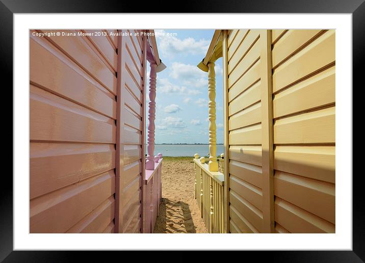 View through the huts West Mersea Essex Framed Mounted Print by Diana Mower