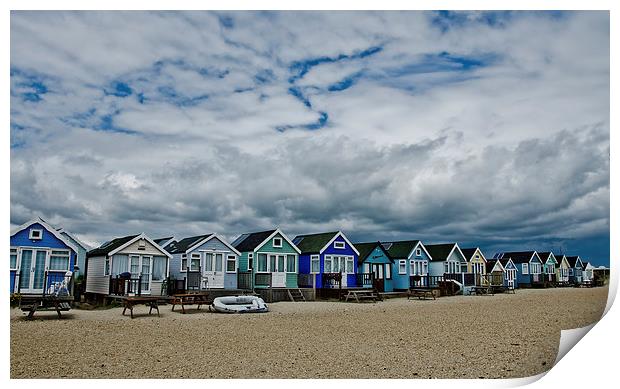 Stormy skys over beach huts Print by Dan Ward