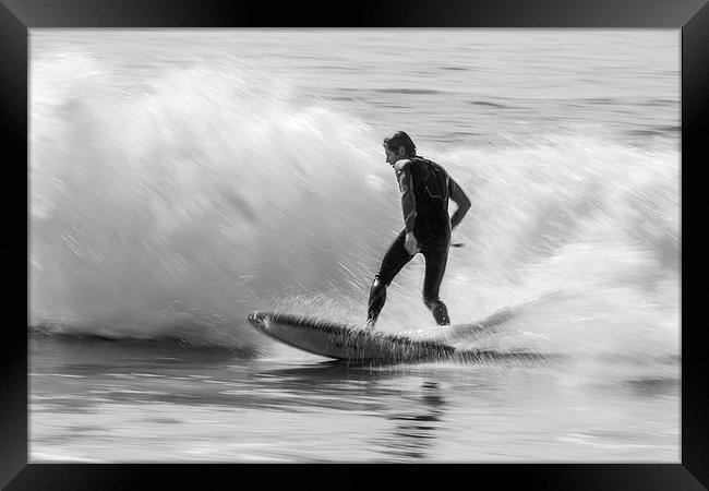 Surfing a beach break Framed Print by Ian Jones