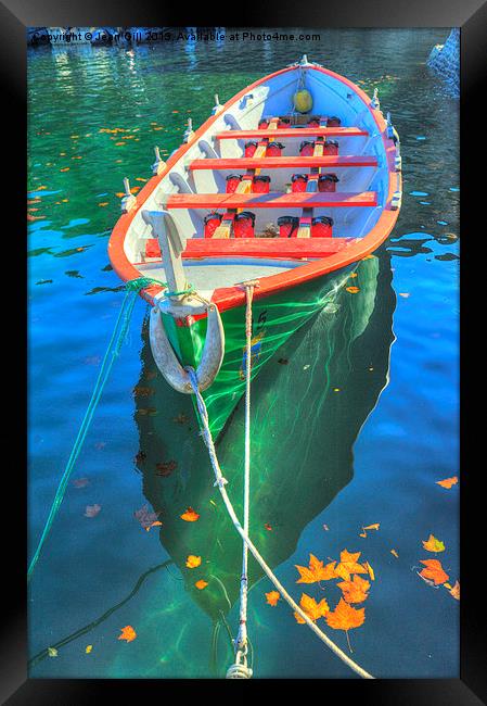 Dinghy and autumn leaves Framed Print by Jean Gill