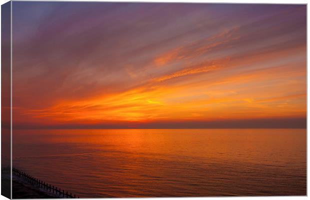Red Sunset over Ocean Canvas Print by Dean Mitchell