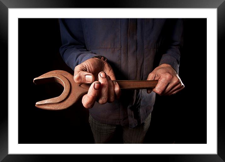 Mechanic holding large wrench Framed Mounted Print by Dean Mitchell