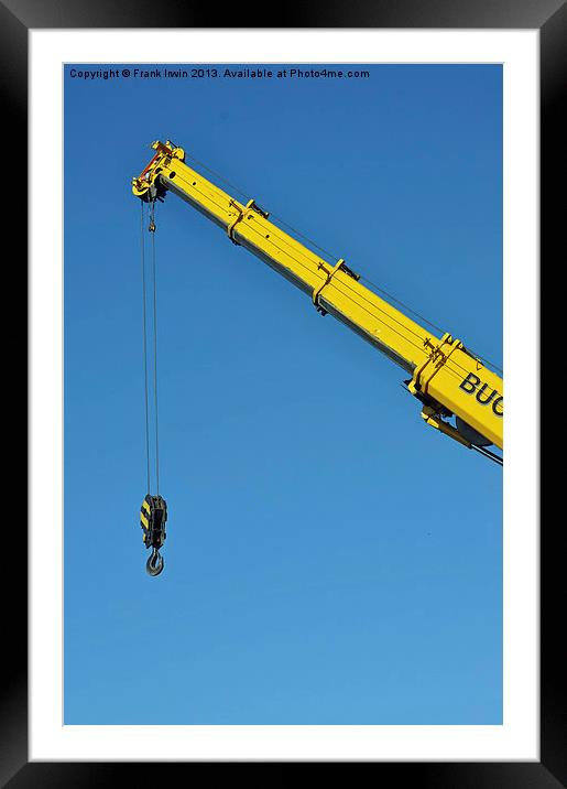 A bright yellow crane jib set against a clear blue Framed Mounted Print by Frank Irwin