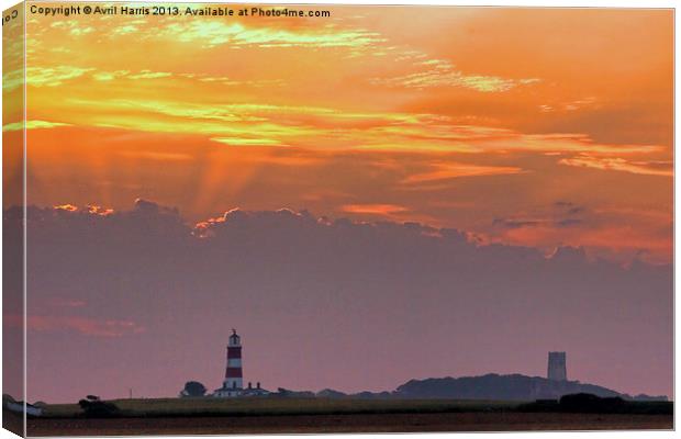 Sun rays over Happisburgh Canvas Print by Avril Harris
