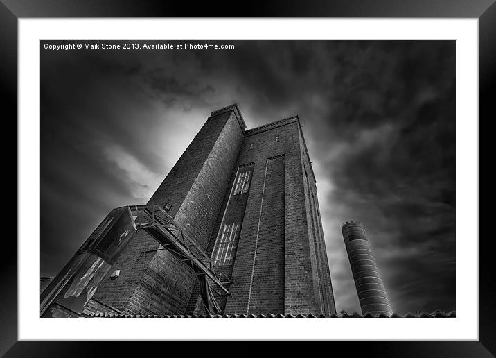 Ominous brick tower & chimney against stormy sky Framed Mounted Print by Mark Stone
