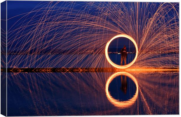 Dramatic golden circle reflecting in water Canvas Print by Mark Stone
