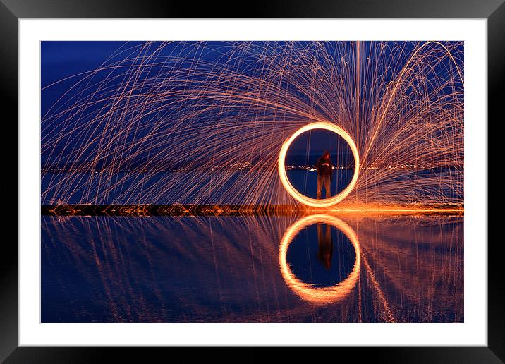 Dramatic golden circle reflecting in water Framed Mounted Print by Mark Stone