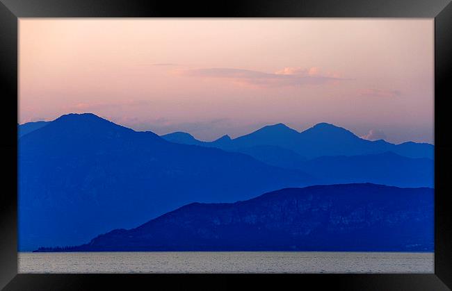 Lake Garda at sun down Framed Print by Peter Lennon