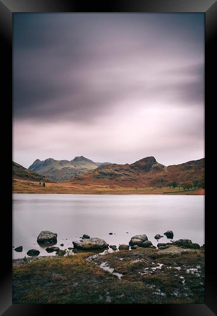 Clouds over Blea Tarn with Langdale Pikes beyond. Framed Print by Liam Grant