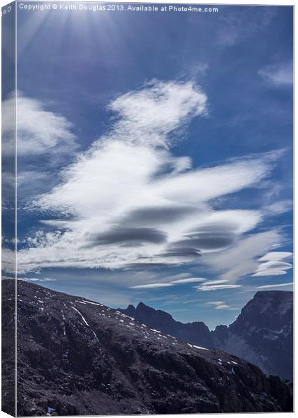 Lenticular clouds and sunrays Canvas Print by Keith Douglas