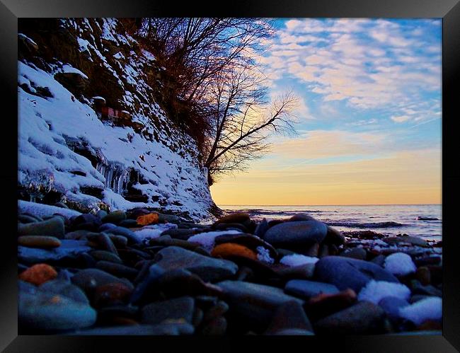A rocky winter sunset. Framed Print by Jeffrey Evans