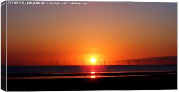 Sunset at the wind farm Canvas Print by John Wain