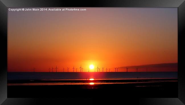 Sunset at the wind farm Framed Print by John Wain