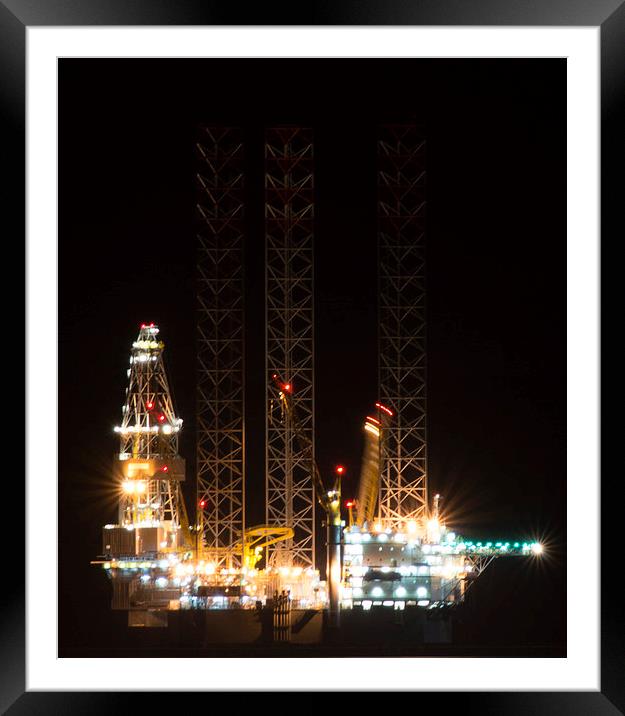 Oil rig at night Framed Mounted Print by caroline henderson