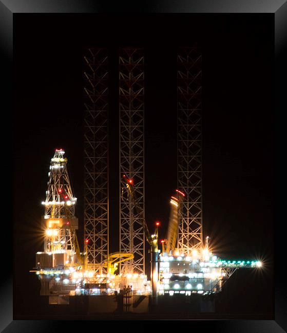 Oil rig at night Framed Print by caroline henderson