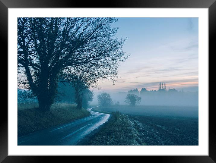 Evening sky over rural road leading into fog. Framed Mounted Print by Liam Grant