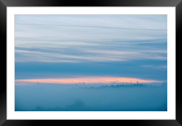 Distant windfarm and evening sky visible through f Framed Mounted Print by Liam Grant