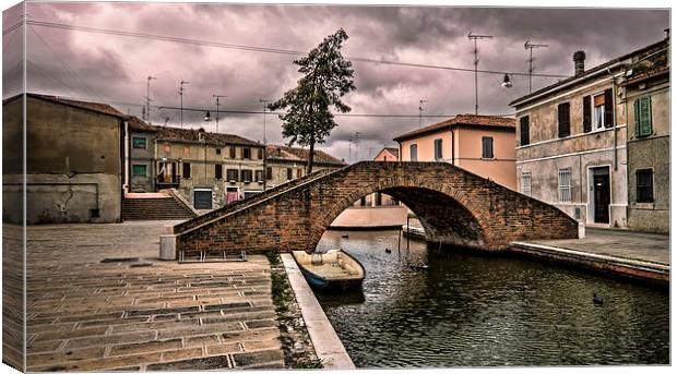 The Carmine bridge in Comacchio Italy Canvas Print by Guido Parmiggiani