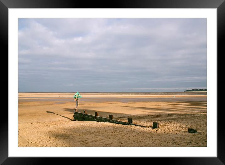 Green groyne marker and sunlit beach under a heavy Framed Mounted Print by Liam Grant