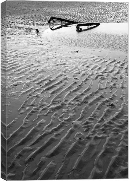 Metal embedded in the sand at low tide. Canvas Print by Liam Grant